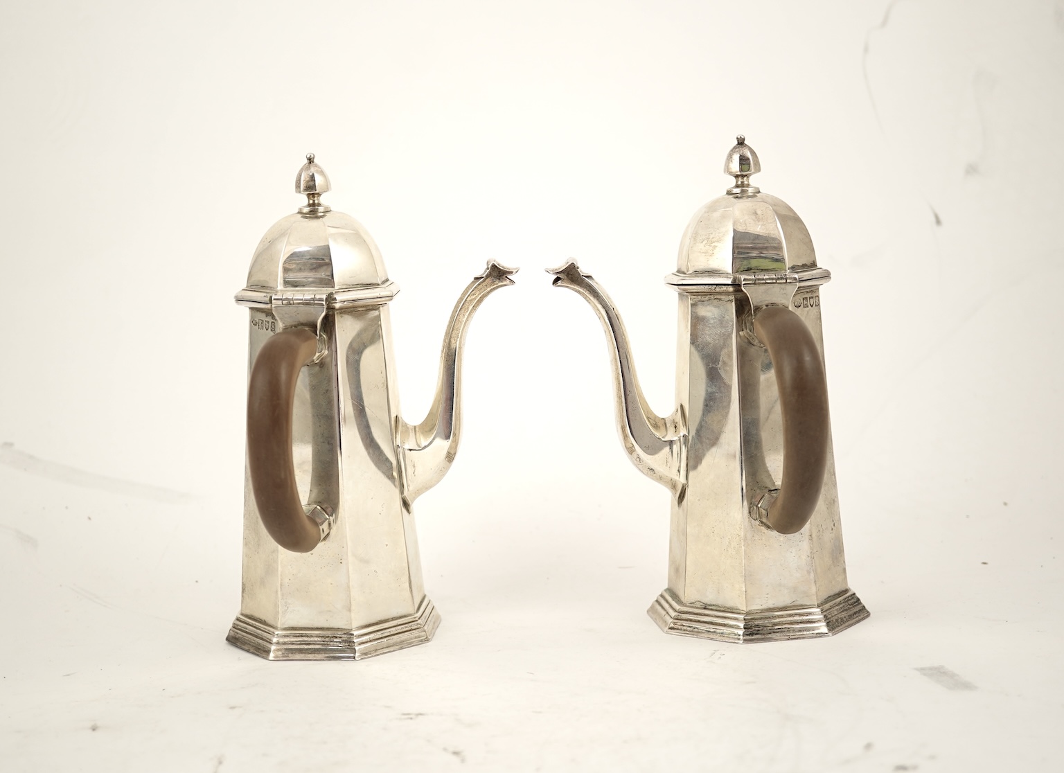 A pair of George V octagonal silver café au lait pots, by William Comyns & Sons Ltd